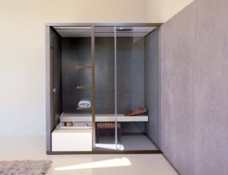 Mid modern Italian luxury sauna room shown with doors in tempered glass. Sauna room composed of sauna, hammam and shower. Comprised features include porcelain glass platform, wooden benches, heater with stones, built-in lower bench bucket, touch control panel, hourglass, aquasteam 45 and handheld shower head. LED RGB lighting system with 5 colors and 4 cycles of white light added for a peaceful and relaxing experience. Optional: sound system and Mid bench with footrest. Sauna room available in sand, cloud and stone (upon request). Effegibi offers a collection of steam room generator and custom steam rooms. Made in Italy.