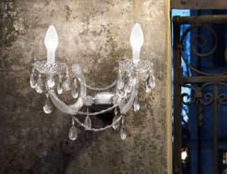 Romantic 165/AP3 Italian designer wall light shown in handmade crystal glass with Swarovski elements. Structure composed of polished chrome metal finish. Sizes available: 1 light, 2 lights, 3 lights (as shown), and 5 lights. Elements available: Swarovski Elements, teak and Spectra crystal. Finishes available: transparent with chrome and teak with iron grey. Collection made with the highest quality materials, showcasing its elegance and beauty. Made in Italy.Made in Italy.