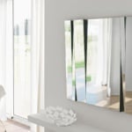 Rectangular wall mirror with angled glass panels in a living room