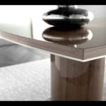 Rectangular wooden table with glossy veneer finish and rounded pedestal base