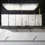 White and black marble kitchen cabinet with geometric panels and dark countertop