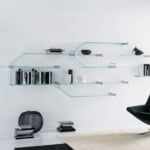 Wall-mounted glass shelving unit with metal supports