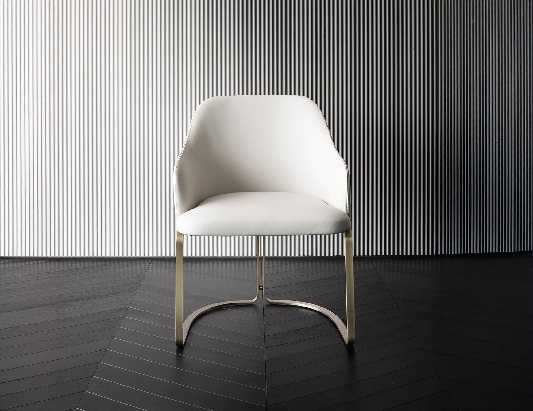 Leather dining chair with curved back and metal legs