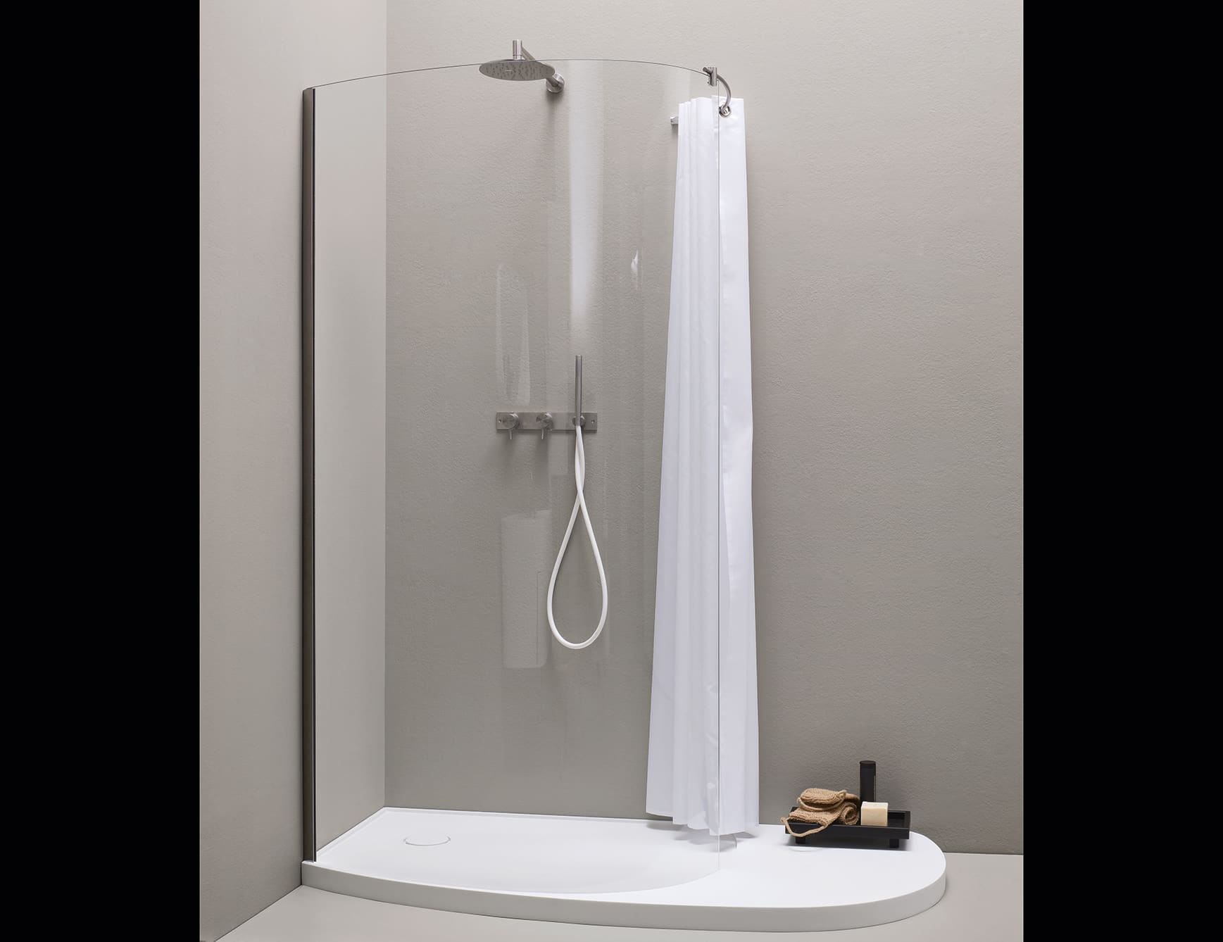Resin shower system with glass panel and curtain in bathroom setting