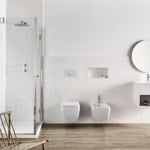Glass shower enclosure in tiled bathroom setting