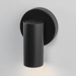 Metal cylindrical wall sconce mounted on light-colored wall