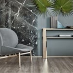 Gray leather lounge chair with metal legs in a living room setting