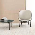 Leather lounge chair with black frame in living room setting