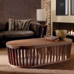 Oval wood coffee table with walnut finish in living room setting
