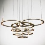 Metal suspension light with multiple circular rings hanging from cables