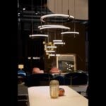 Labilis metal suspension light with circular ring design hanging above seating area