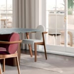 Wooden frame dining chairs with fabric upholstery.