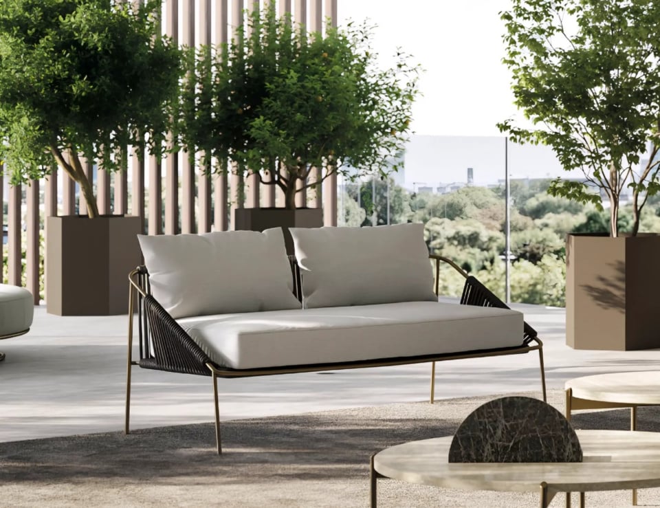 Modern patio with stylish furniture and trees.