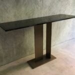 Wood console table with ebony finish and twin pedestal base