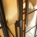 Wood bookcase with metal frame and ribbed glass doors