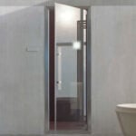 Glass steam room generator door in bathroom setting