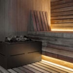 Wood sauna interior with heater and stone compartment