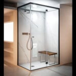 Glass steam room sauna with metal frame and wooden bench