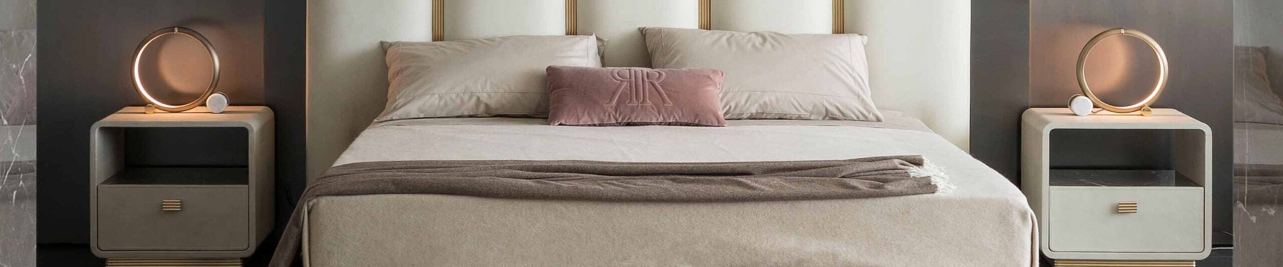 Upholstered bed with beige headboard and two wooden bedside tables