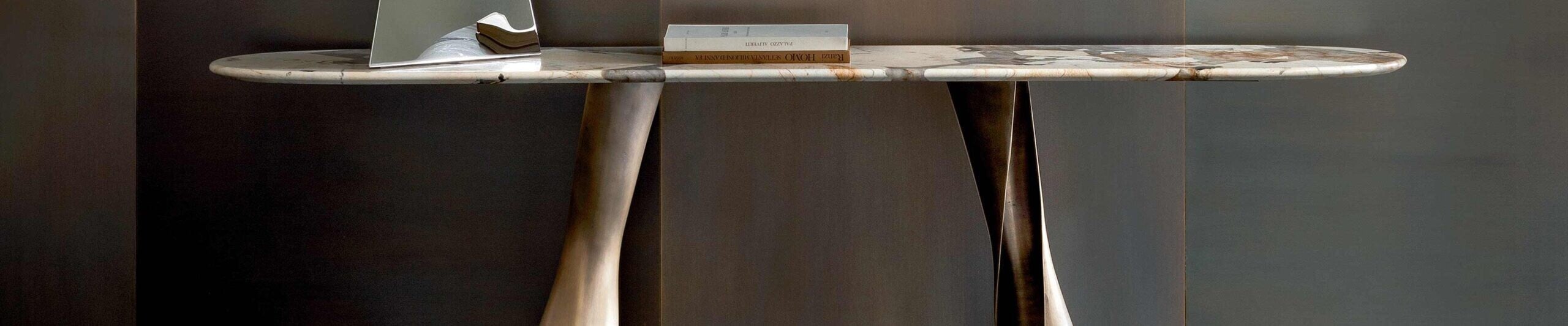 Marble console table with metal legs against dark wall