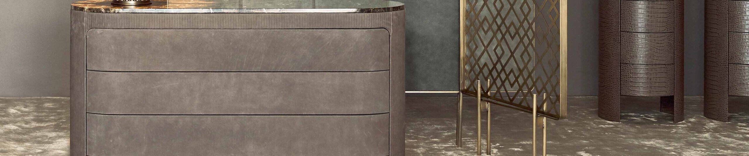 Gray leather dresser with marble top in interior setting
