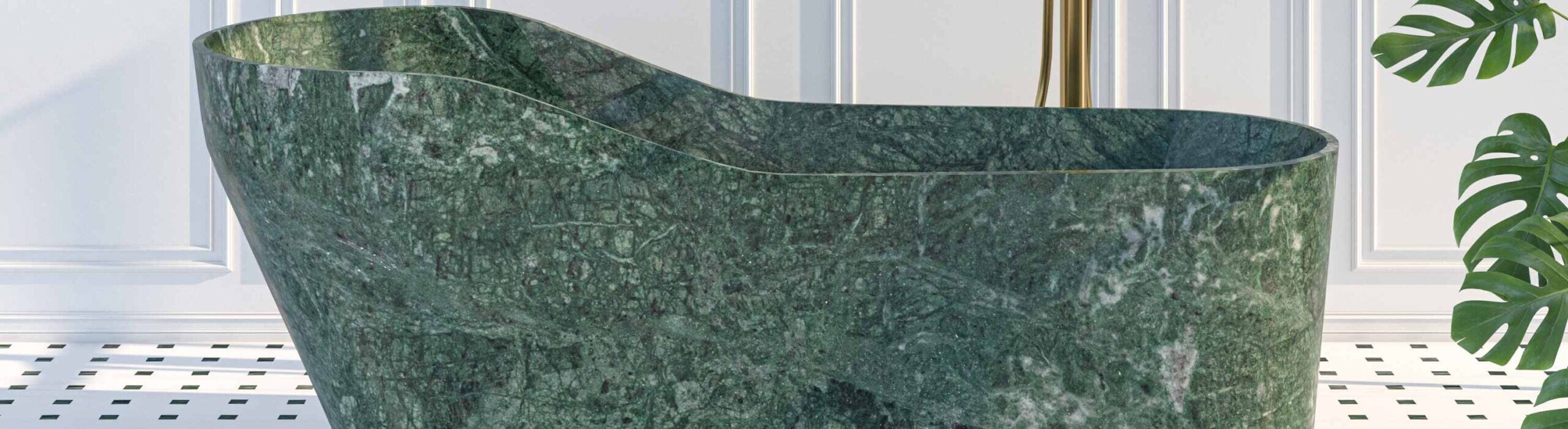 Green marble freestanding bathtub with curved rim in white tiled bathroom