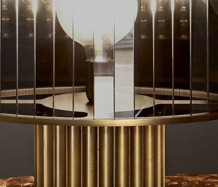 Metal table lamp with ribbed base and cylindrical glass shade