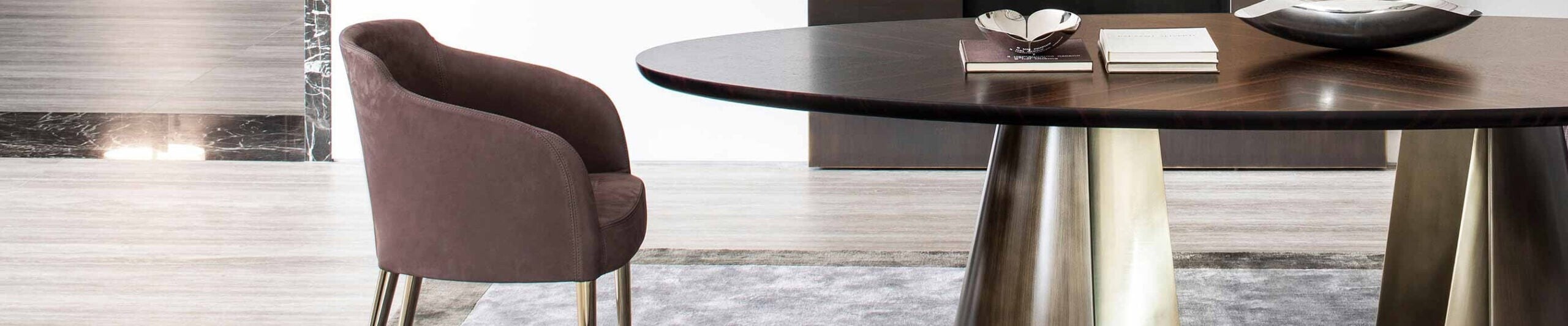 Upholstered dining chair with metal legs beside wooden table with metal base