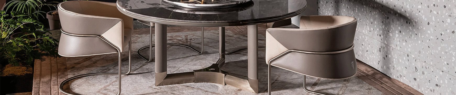 Round marble table with metal base and leather chairs