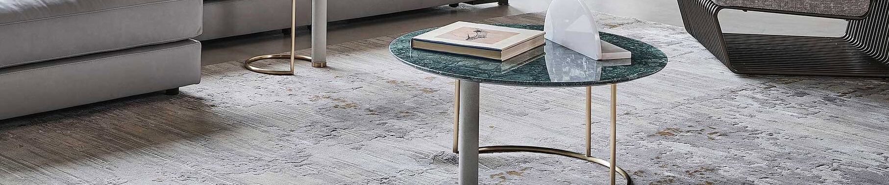 Round glass and metal coffee table with marble top in living room
