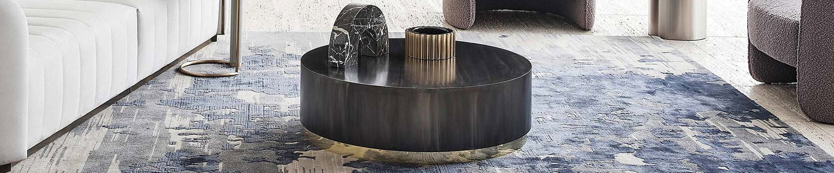 Round metal coffee table with dark polished finish in living room