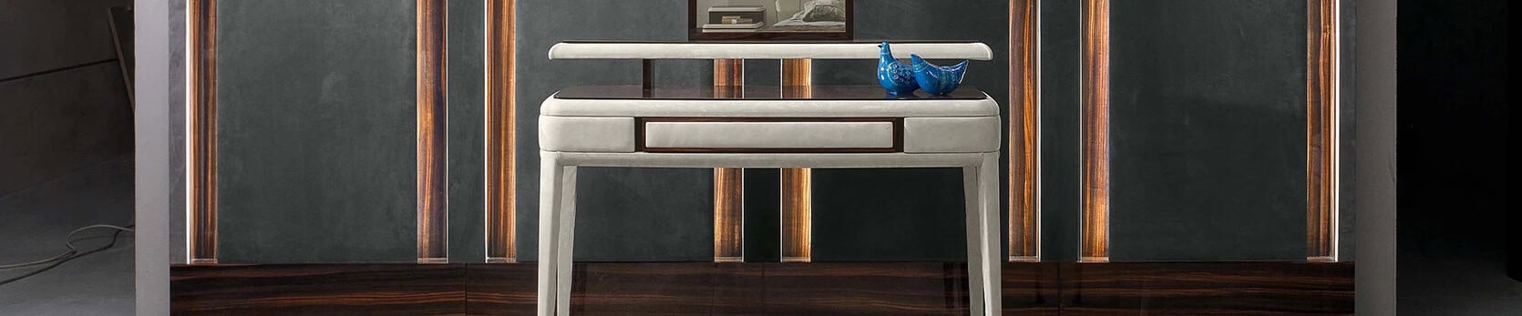 Wood and leather vanity table with drawer in front of dark wall