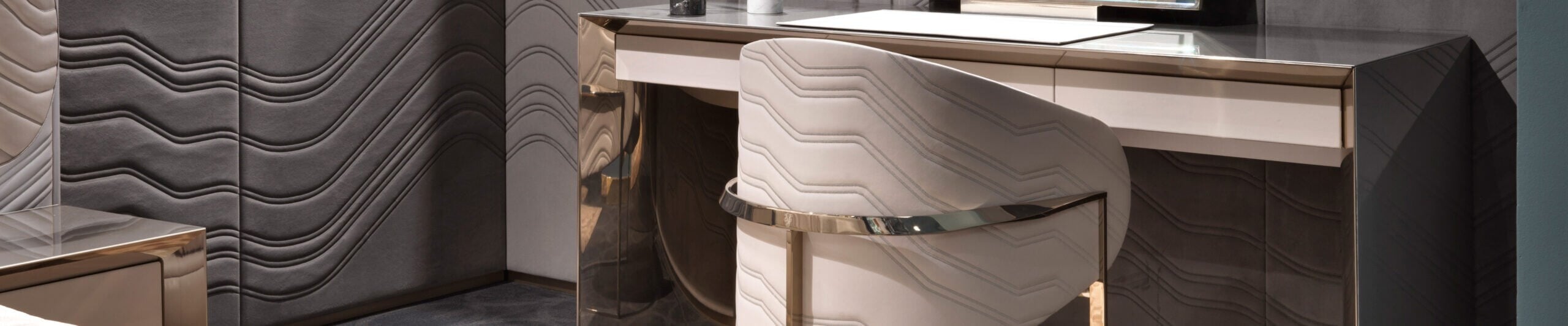 Wood and metal vanity desk with upholstered chair in patterned panel room