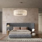 Upholstered fabric bed with textured headboard and wood bedside tables in bedroom setting