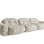 Three-seater fabric sofa with tufted cushions and rounded form