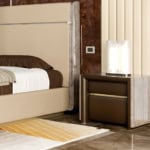 Leather bedside table with walnut finish and two drawers beside bed