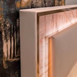 Leather storage bed headboard with marble panel detail.