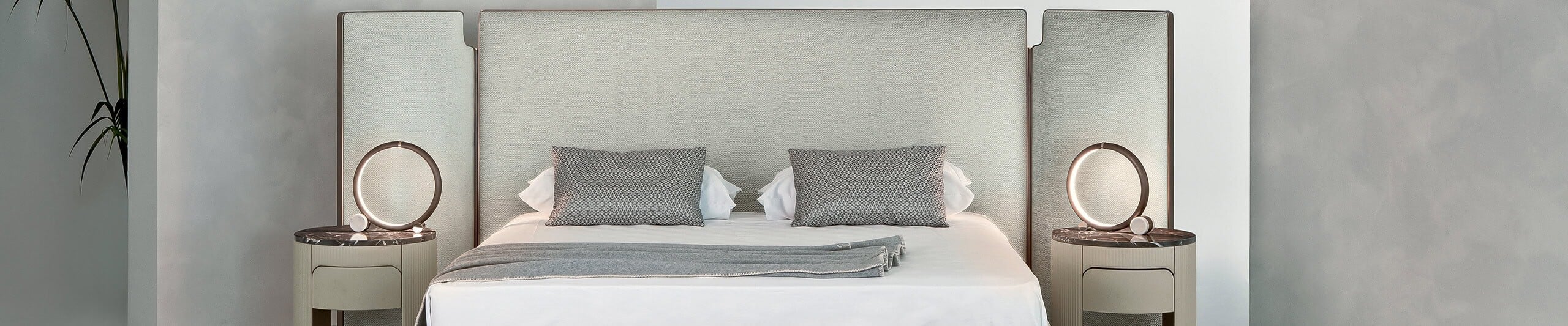 Upholstered bed with tall fabric headboard and matching nightstands