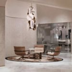 Upholstered leather office armchairs with metal base around a low table in a seating area