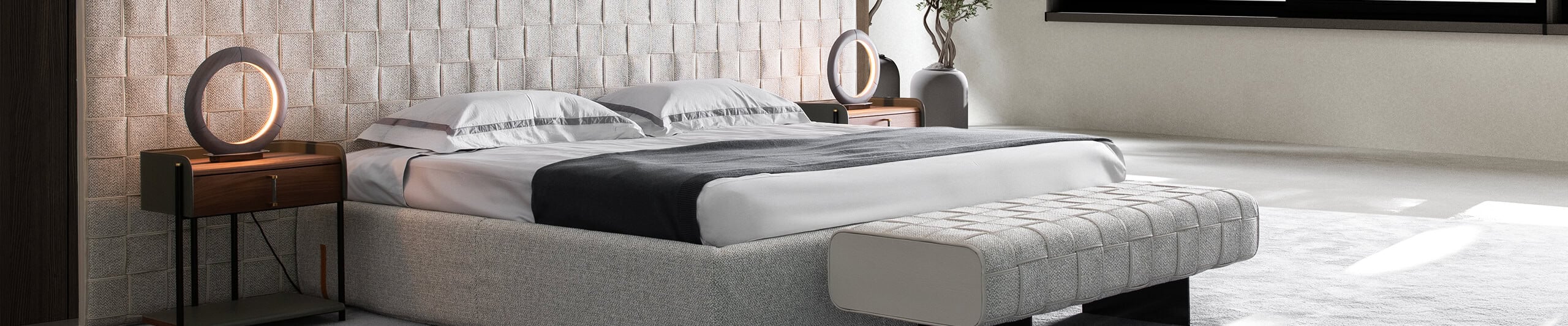 Upholstered bed with fabric headboard and wooden nightstands in bedroom setting