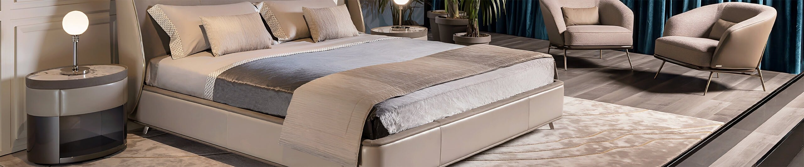 Upholstered leather bed with fabric bedding and side tables in a bedroom setting