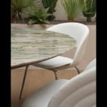 Round outdoor dining table with marble top and wood base
