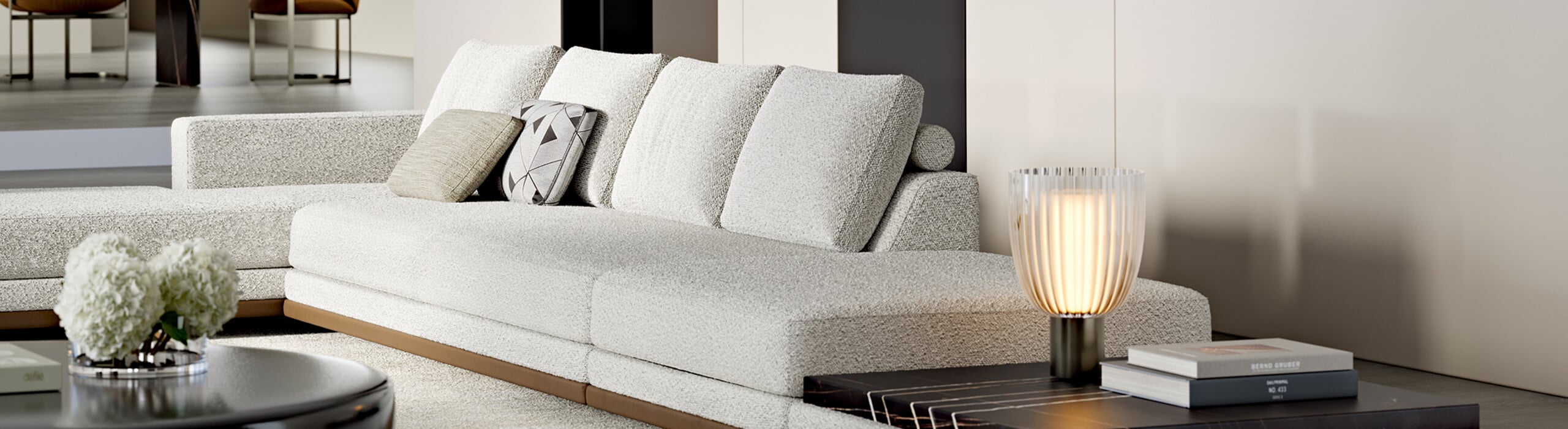 Light gray fabric sectional sofa with cushions in a living room.