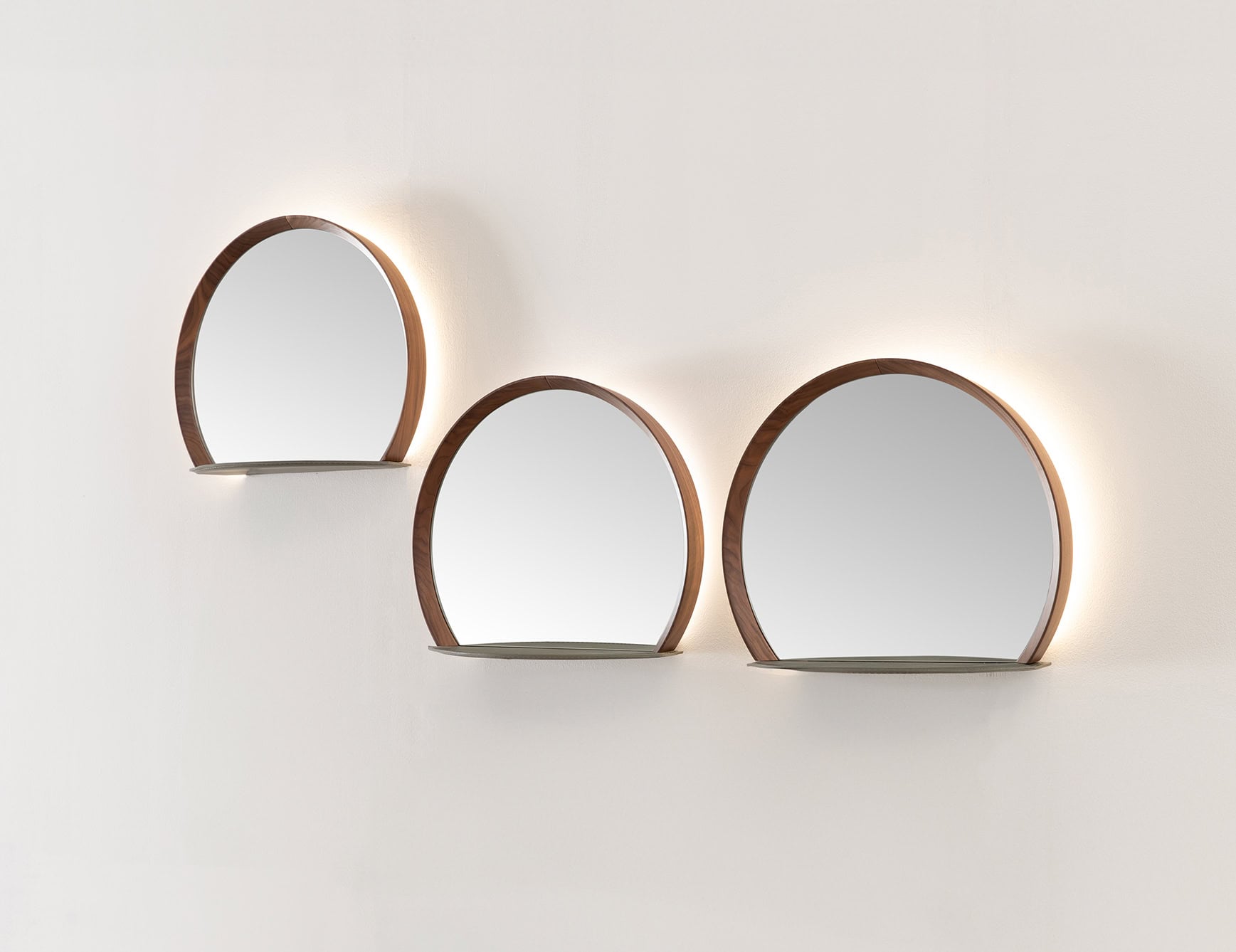 Round wood mirrors with American walnut finish mounted on wall