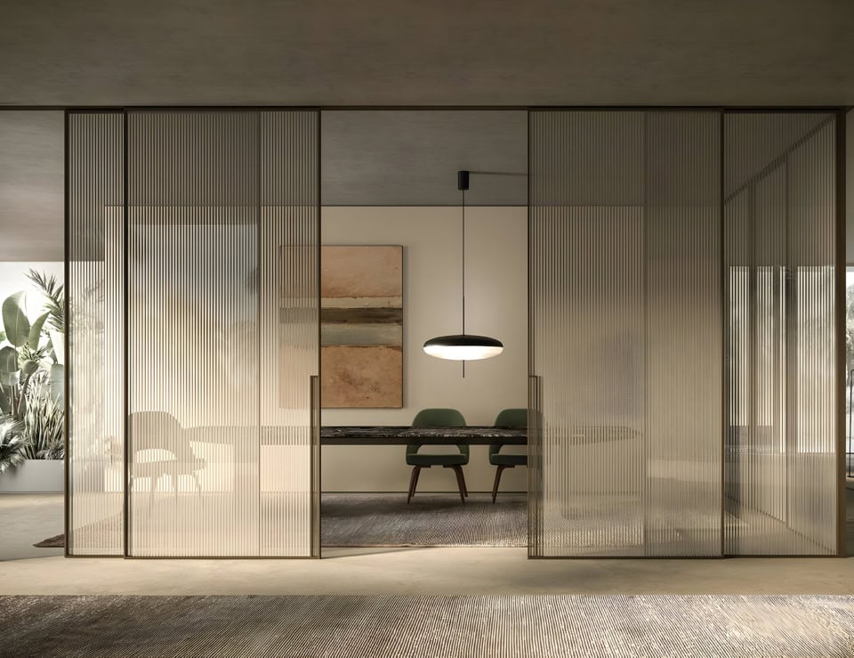 Glass sliding doors with vertical ribbed panels in interior setting