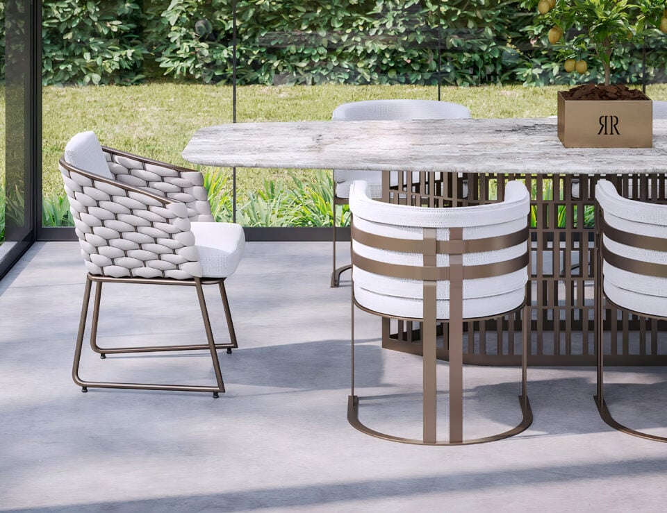 Fabric dining chair with metal frame shown near a dining table in an outdoor setting