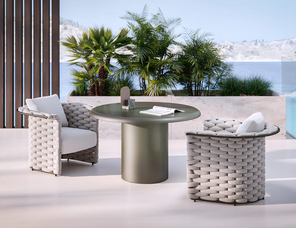 Fabric outdoor armchair with woven design near patio table