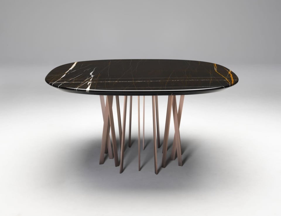 Oval marble dining table with Sahara Noir finish and metal base