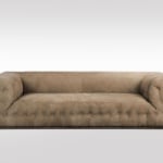 Fabric upholstered sofa with tufted details and low backrest