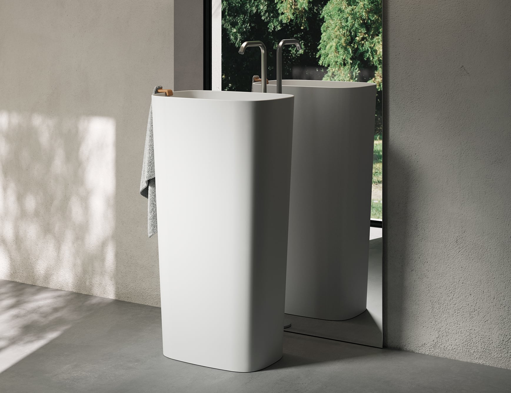 Tall resin washbasin with towel in bathroom.